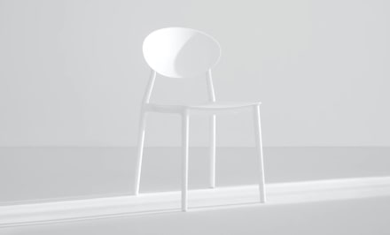 White chair against a gray background.